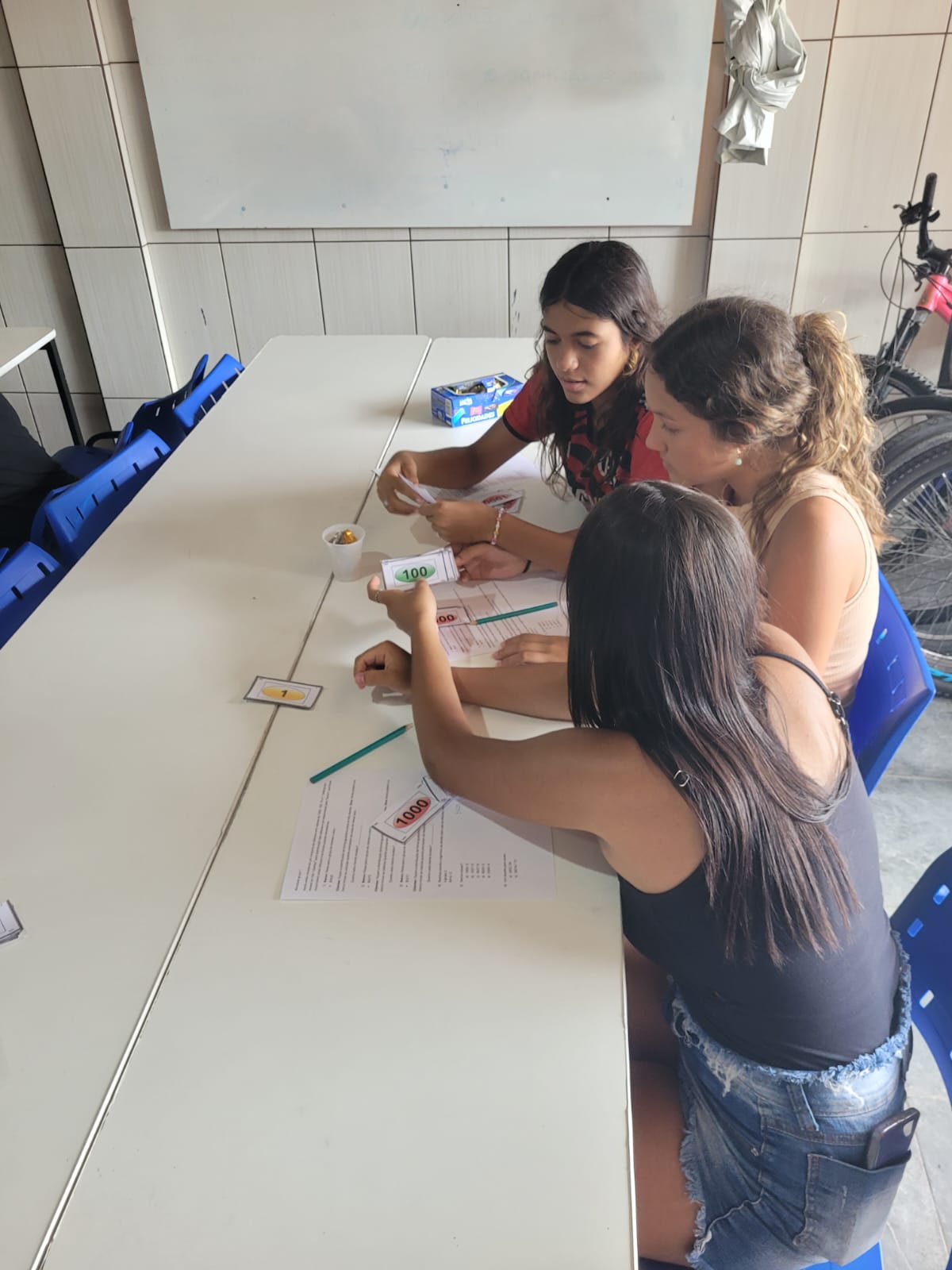 Imagem 1 Grupo de alunas interagindo com as cédulas desenvolvidas pelos licenciandos